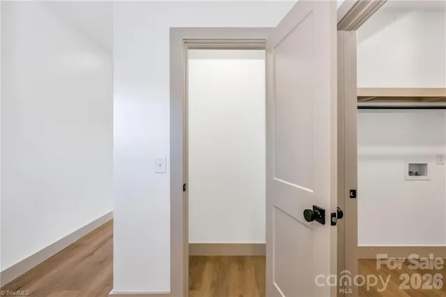 a view of a hallway with wooden floor