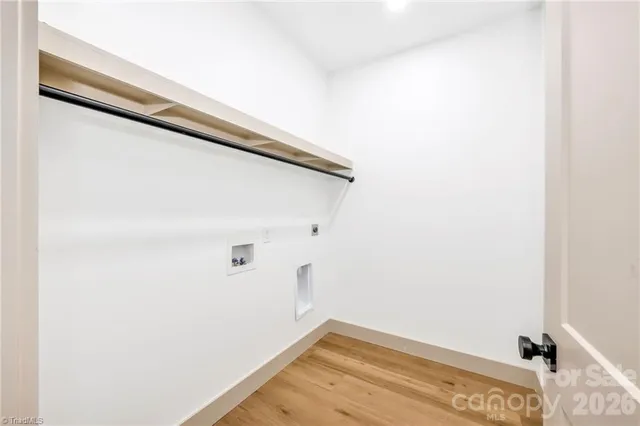 a view of a room with wooden floor