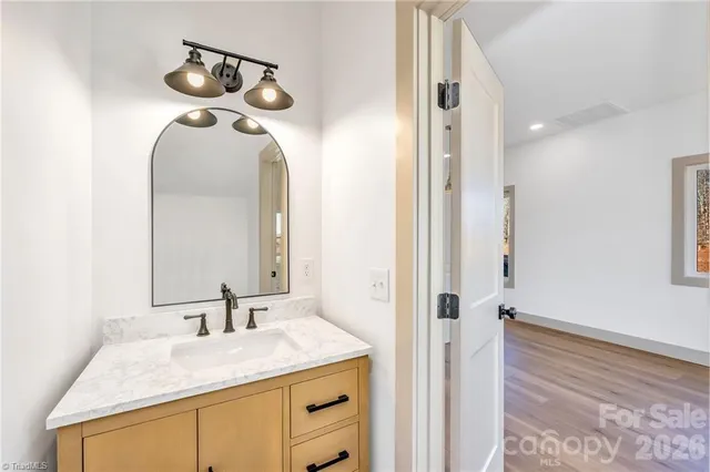 a bathroom with a granite countertop sink and a mirror
