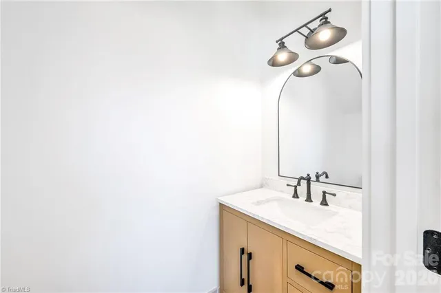 a bathroom with a sink vanity and a mirror