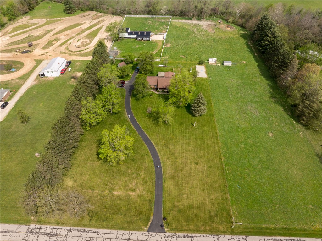 7988 McCool Road Greenville, OH 45331 - Photo 39 of 50 This aerial view showcases a spacious property with a private driveway and lush green surroundings.
