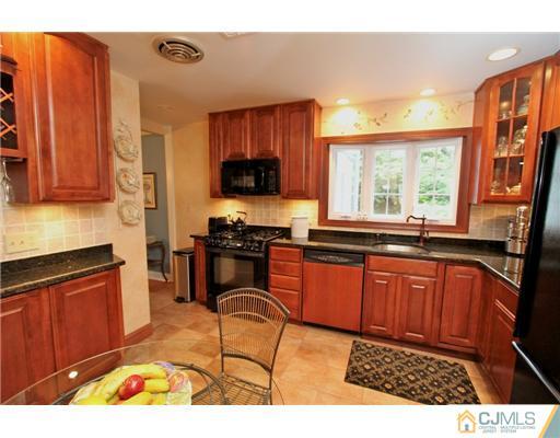 386 Plainfield Road Edison, NJ 08820 - Photo 3 of 17 a kitchen with stainless steel appliances granite countertop a stove a sink and a microwave