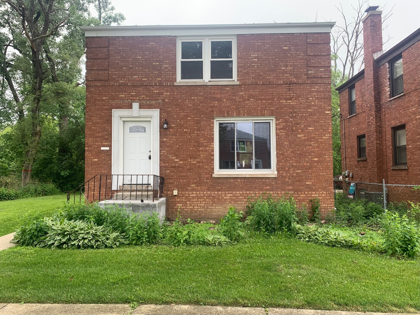 a brick building with a yard in front of it