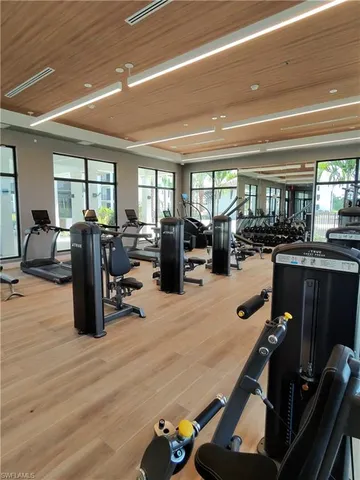 a room with lots of chairs and mirrors