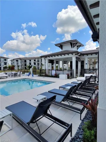 a view of a patio with swimming pool table and chairs