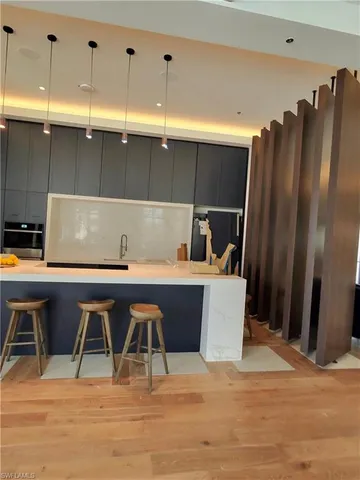 a room with table chairs and wooden floor