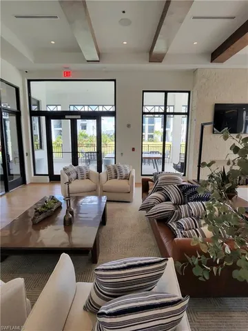 a bedroom with furniture and a large window