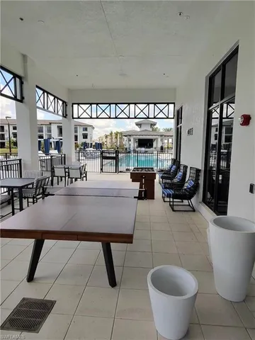 a living room with furniture a rug and white walls