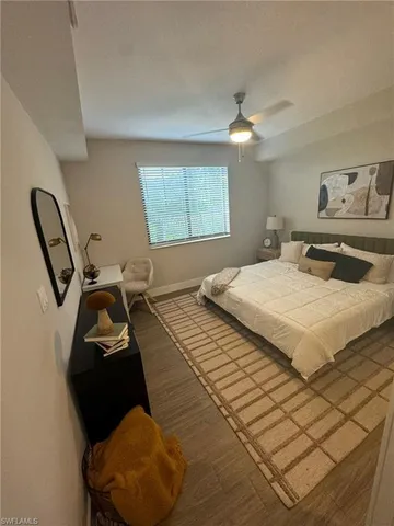 a bedroom with a bed mirror and window