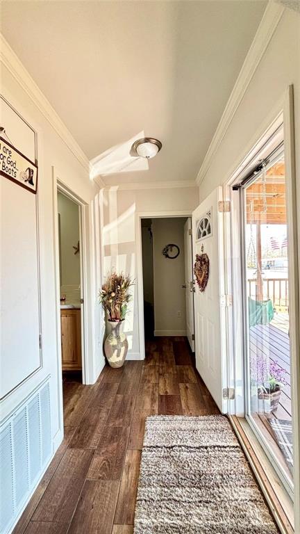 269 Apache Quitman, TX 75783 - Photo 5 of 40 a view of a hallway to a livingroom with wooden floor and windows