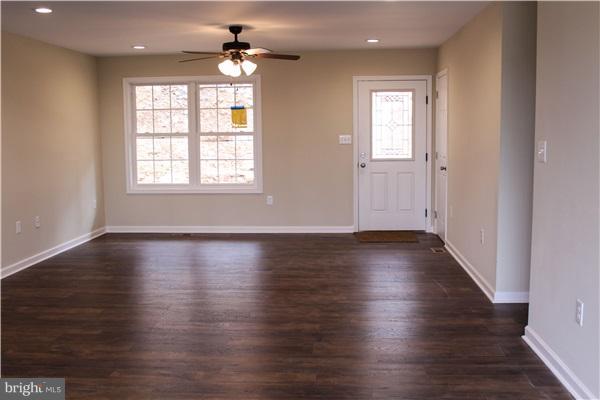 125 Bridle Path Road Front Royal, VA 22630 - Photo 6 of 6 an empty room with wooden floor and windows