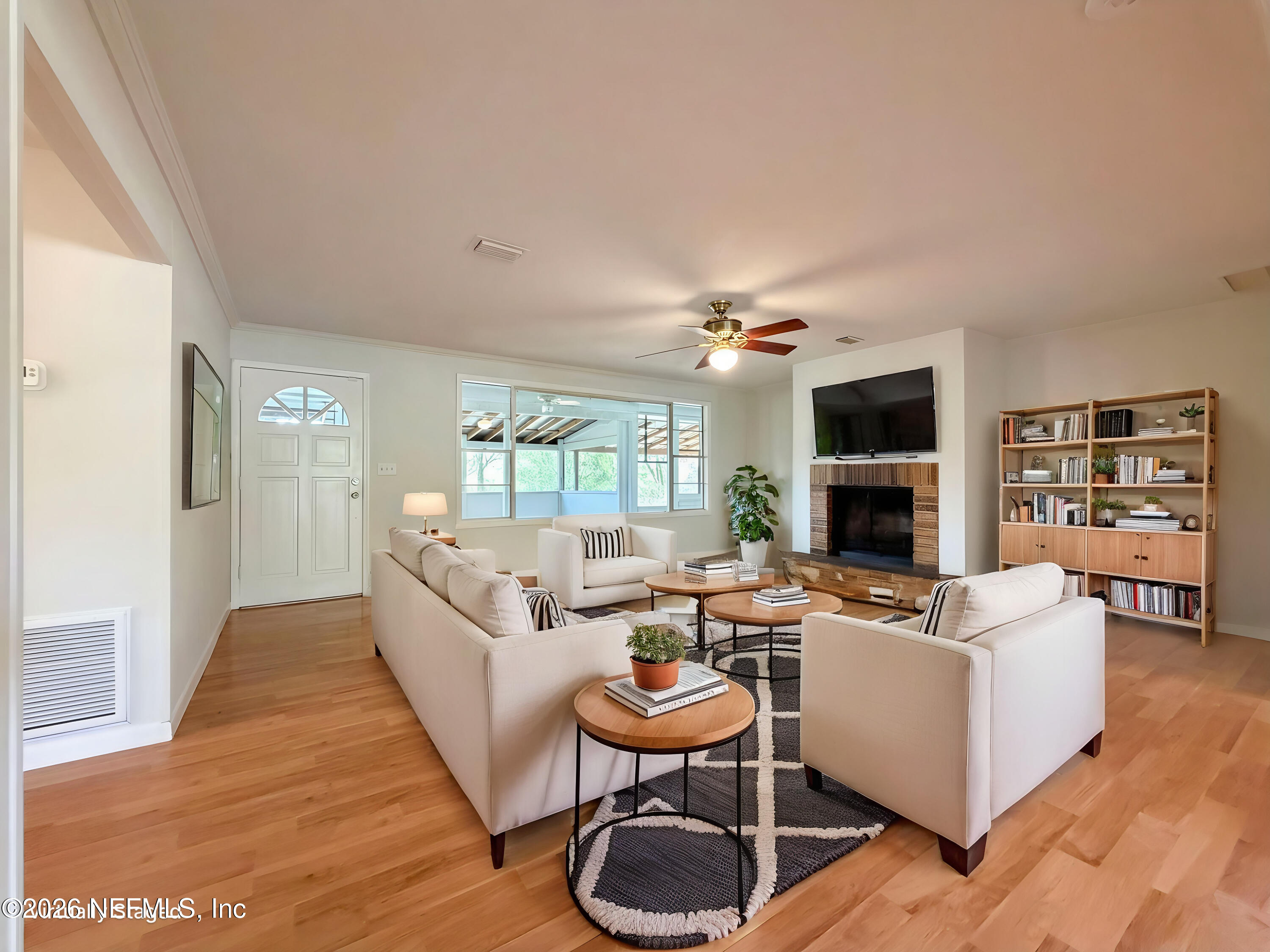 6917 Gatorbone Road Keystone Heights, FL 32656 - Photo 3 of 24 a living room with furniture a fireplace and a flat screen tv