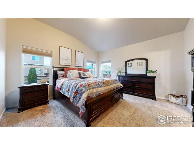 a bedroom with a bed window and dresser