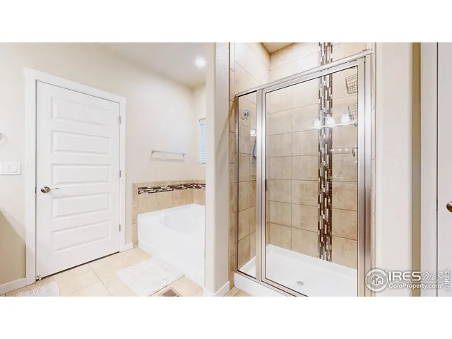 a bathroom with a glass shower door and a bathtub