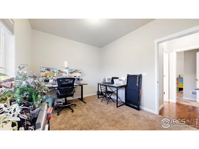 a living room with furniture and a piano