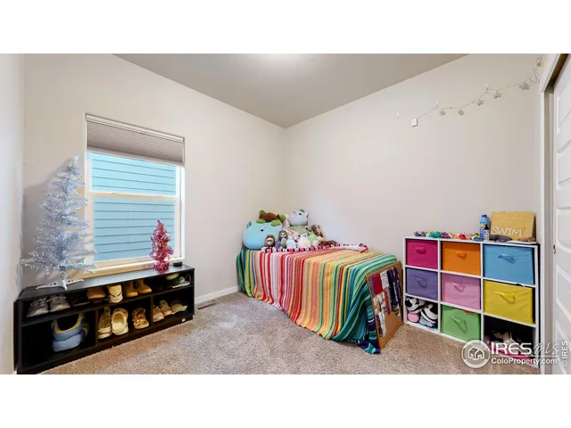 a living room with baby crib furniture and a couch