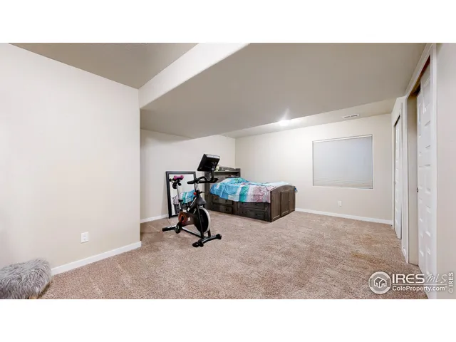 a living room with furniture and a gym machine