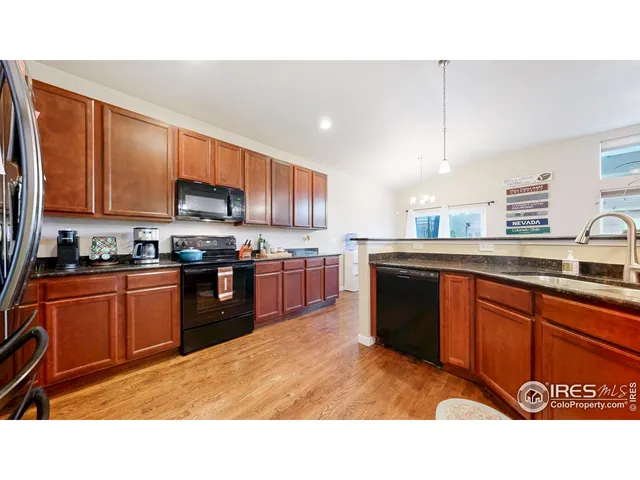 a open kitchen with stainless steel appliances granite countertop a stove a sink dishwasher and a refrigerator