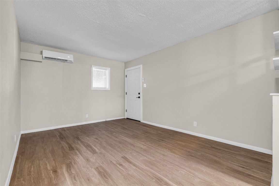 4706 Yellowstone Boulevard, Unit 11 Houston, TX 77021 - Photo 11 of 13 a view of an empty room with wooden floor and a window