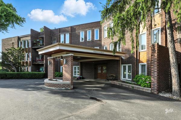 1425 Sandpebble Drive, Unit 340 Wheeling, IL 60090 - Photo 3 of 14 a front view of a house with a yard