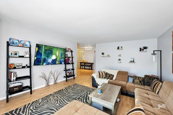 1425 Sandpebble Drive, Unit 340 Wheeling, IL 60090 - Photo 8 of 14 a living room with furniture and a flat screen tv