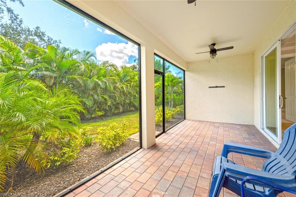 388 Grace Bay Lane Naples, FL 34114 - Photo 21 of 39 Unfurnished sunroom with a ceiling fan, brick floors, and a patio area