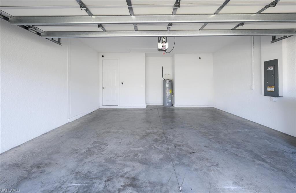 388 Grace Bay Lane Naples, FL 34114 - Photo 24 of 39 Garage with electric panel and water heater