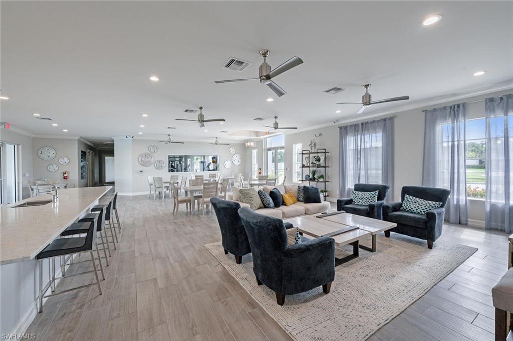 388 Grace Bay Lane Naples, FL 34114 - Photo 34 of 39 Living room with ornamental molding, recessed lighting, light wood-type flooring, and a ceiling fan