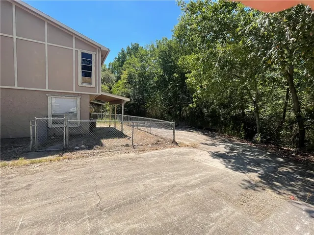 a view of a backyard with chairs