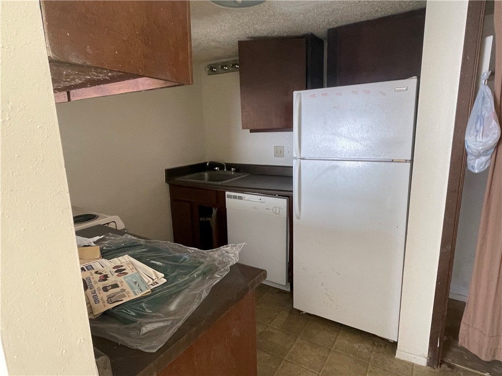 5900 Leonard Road Bryan, TX 77807 - Photo 22 of 27 a kitchen with a refrigerator and a stove top oven