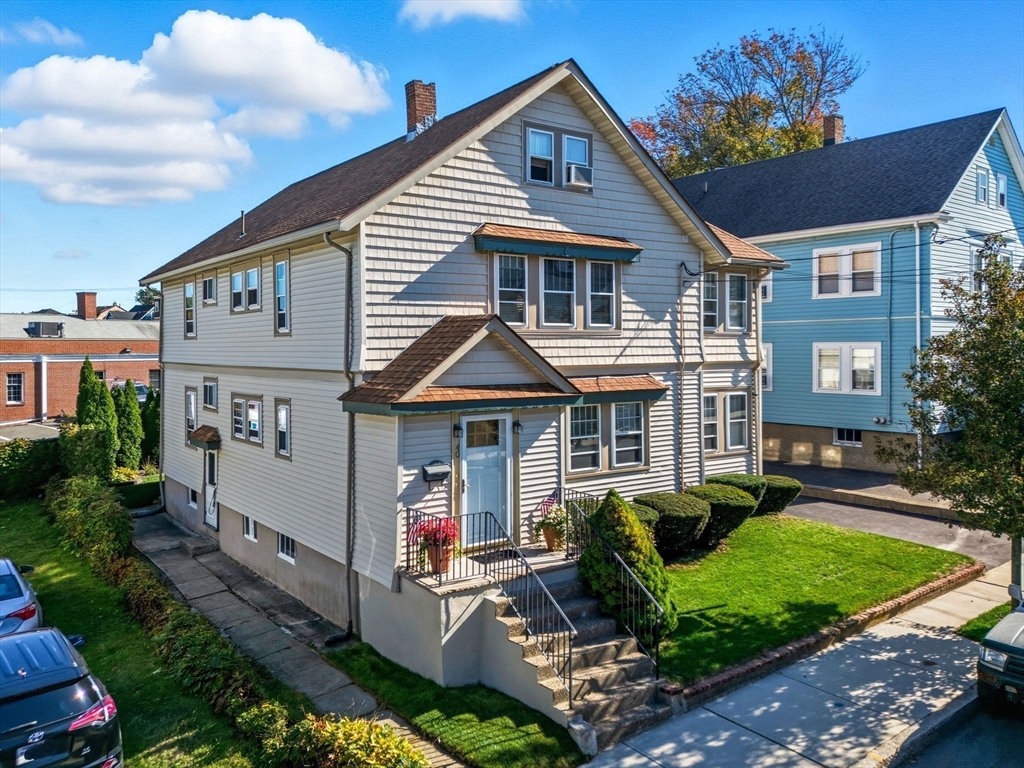 a front view of a house with garden