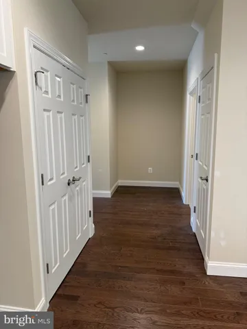 a view of a livingroom with furniture a flat screen tv and kitchen view