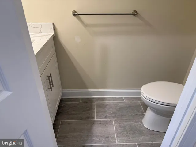 a kitchen with a refrigerator and a stove top oven