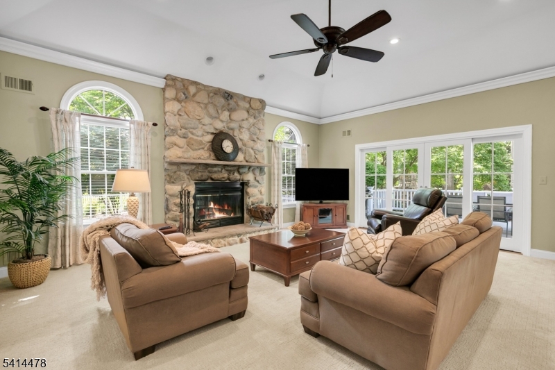 33 St Nickolas Way Bernards, NJ 07920 - Photo 10 of 50 a living room with furniture a flat screen tv and a fireplace