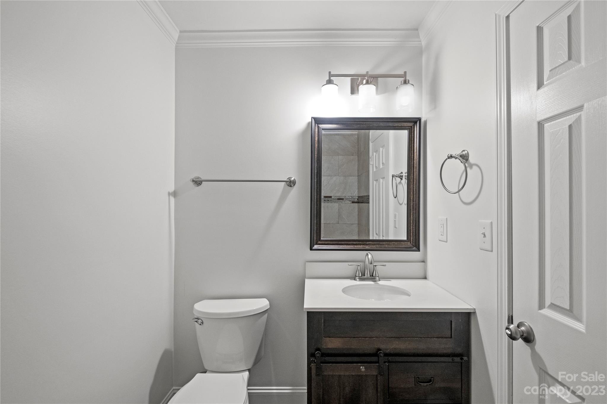 3522 Enfield Road Charlotte, NC 28205 - Photo 21 of 32 a bathroom with a sink a toilet and mirror