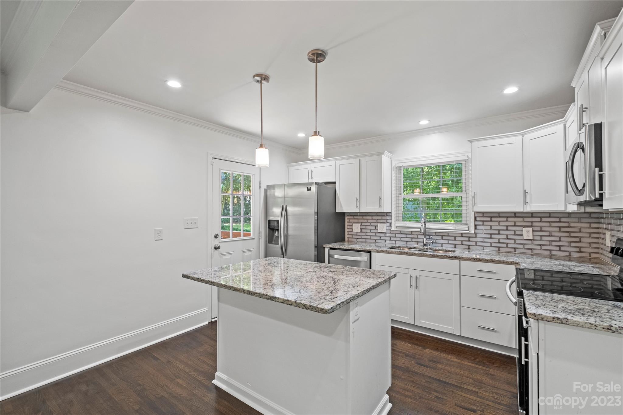 3522 Enfield Road Charlotte, NC 28205 - Photo 8 of 32 a kitchen with granite countertop a sink cabinets and window