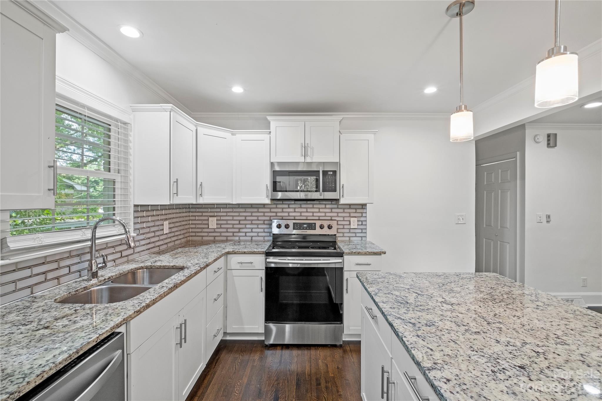 3522 Enfield Road Charlotte, NC 28205 - Photo 10 of 32 a kitchen with stainless steel appliances granite countertop a sink stove and refrigerator