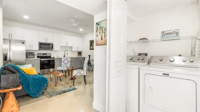 a kitchen with white cabinets and white appliances