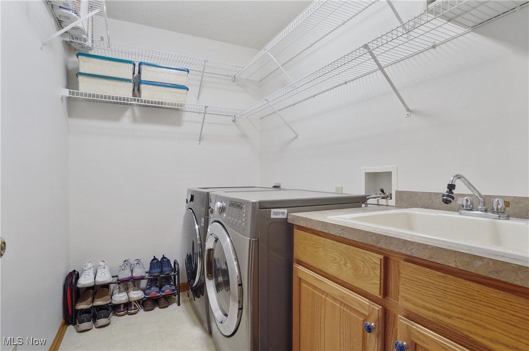 4265 Ridge Crest Drive Akron, OH 44321 - Photo 21 of 49 Laundry room featuring washing machine and clothes dryer and cabinet space