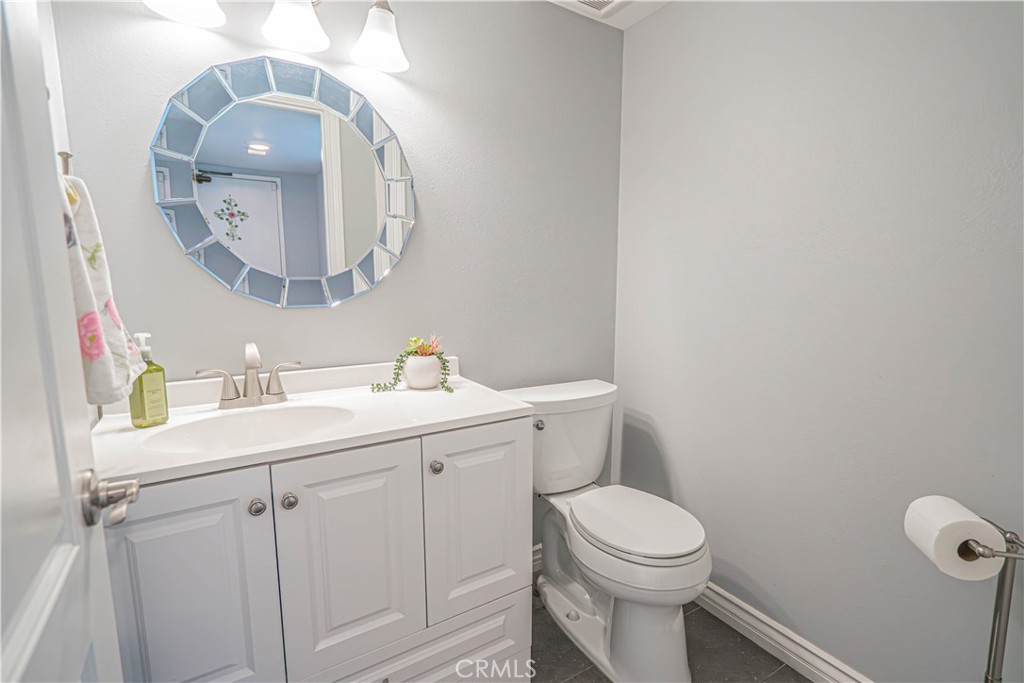 27738 Hyssop Lane Saugus, CA 91350 - Photo 19 of 43 a bathroom with a toilet a sink and mirror