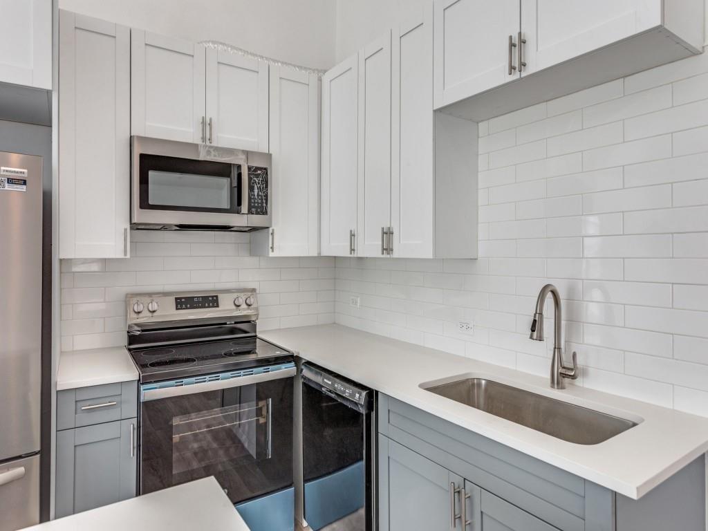 3821 Horizon Place Fort Worth, TX 76133 - Photo 3 of 19 a kitchen with white cabinets a sink and stainless steel appliances