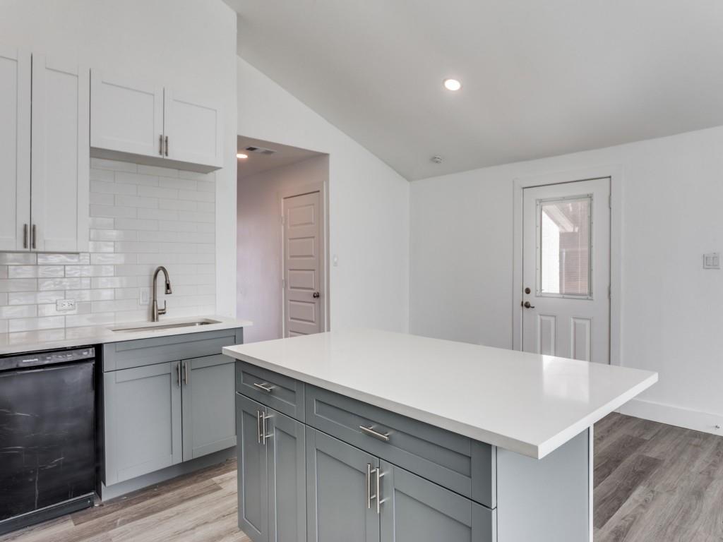 3821 Horizon Place Fort Worth, TX 76133 - Photo 4 of 19 a kitchen with a sink dishwasher a stove and white cabinets with wooden floor