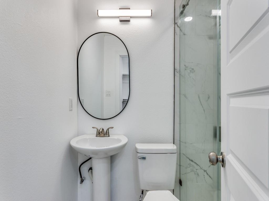 3821 Horizon Place Fort Worth, TX 76133 - Photo 10 of 19 a bathroom with a sink a mirror a toilet and a shower