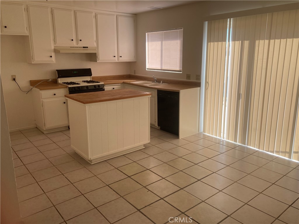 13237 Mohawk Road Apple Valley, CA 92308 - Photo 16 of 21 a kitchen with granite countertop white cabinets and white appliances