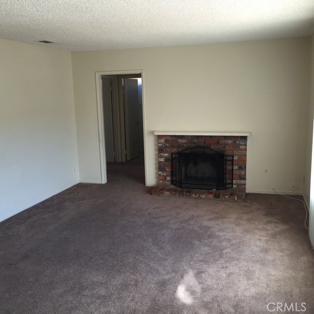 13237 Mohawk Road Apple Valley, CA 92308 - Photo 6 of 21 a view of empty room with a fireplace