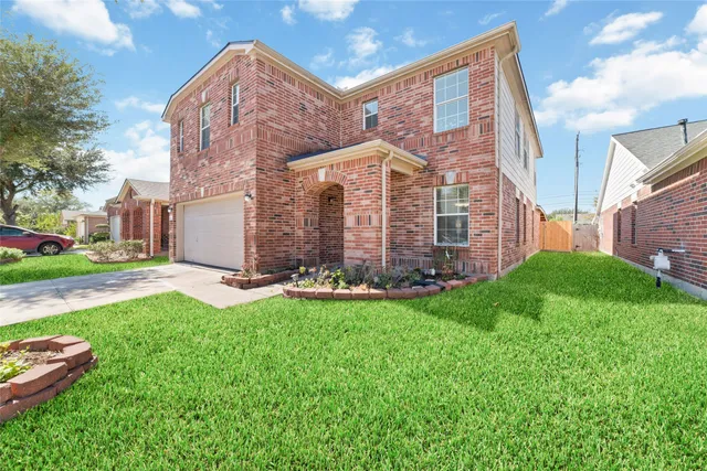 a view of a house with a backyard