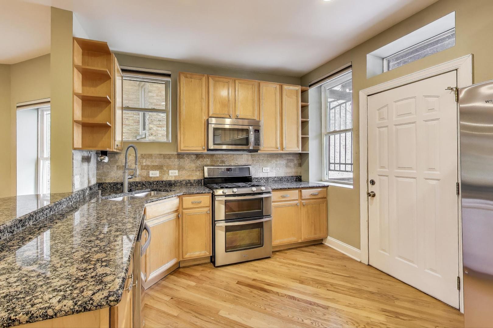 7730 North Paulina Street, Unit 1 Chicago, IL 60626 - Photo 12 of 59 a kitchen with stainless steel appliances granite countertop a stove a sink and a refrigerator
