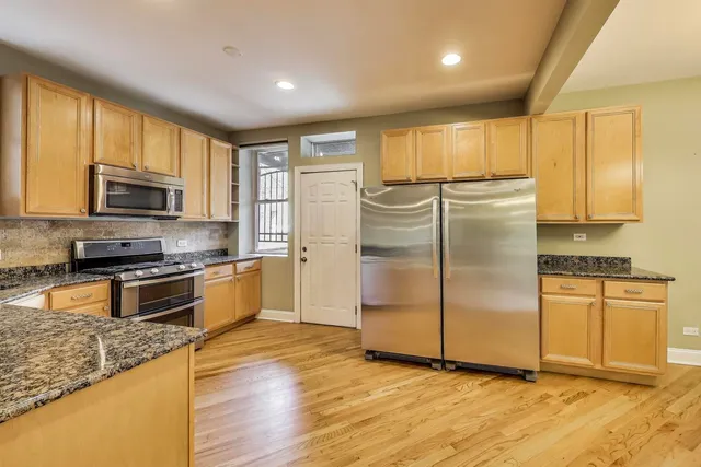 a kitchen with stainless steel appliances a stove top oven and sink