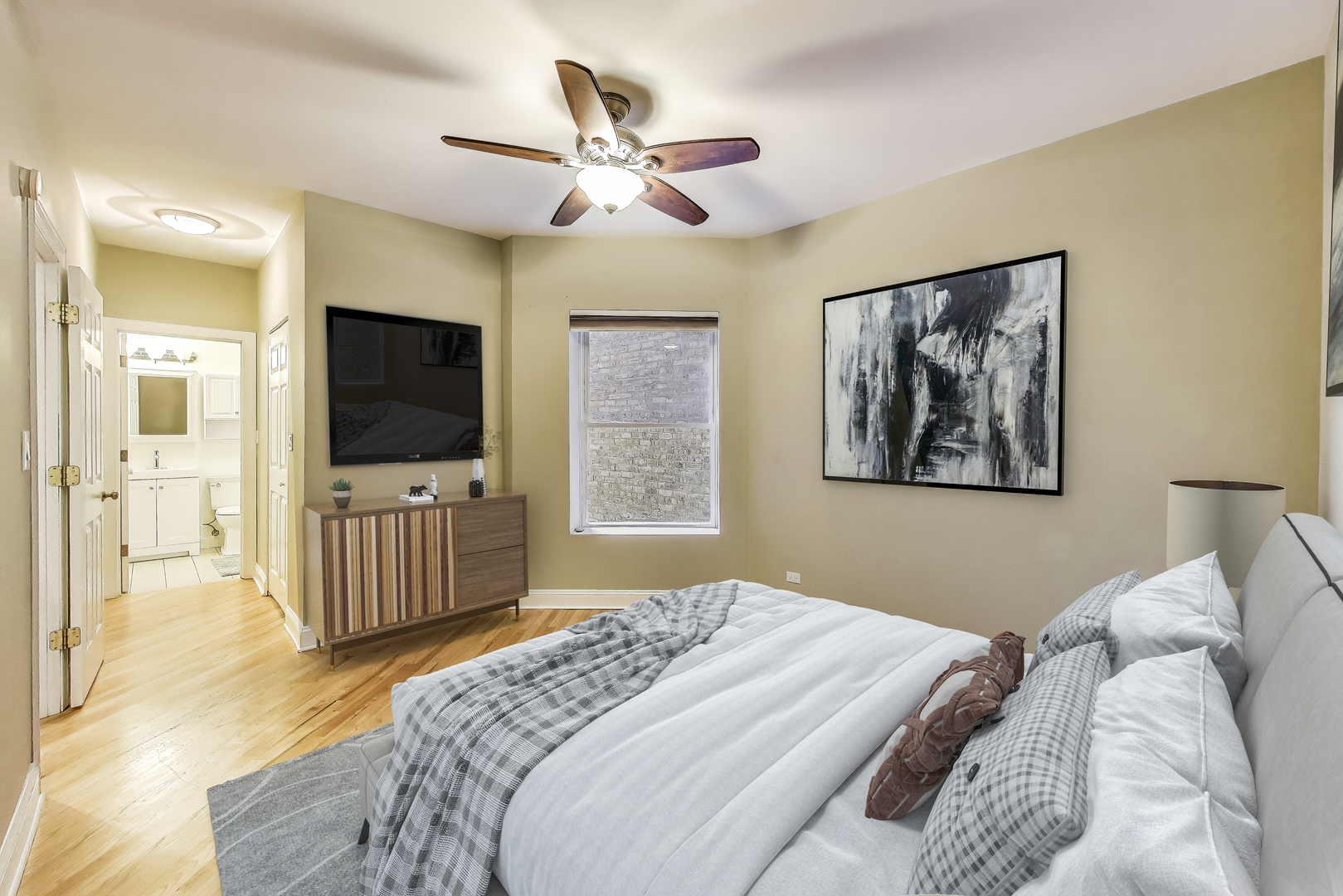 7730 North Paulina Street, Unit 1 Chicago, IL 60626 - Photo 23 of 59 a bedroom with a bed and a flat screen tv