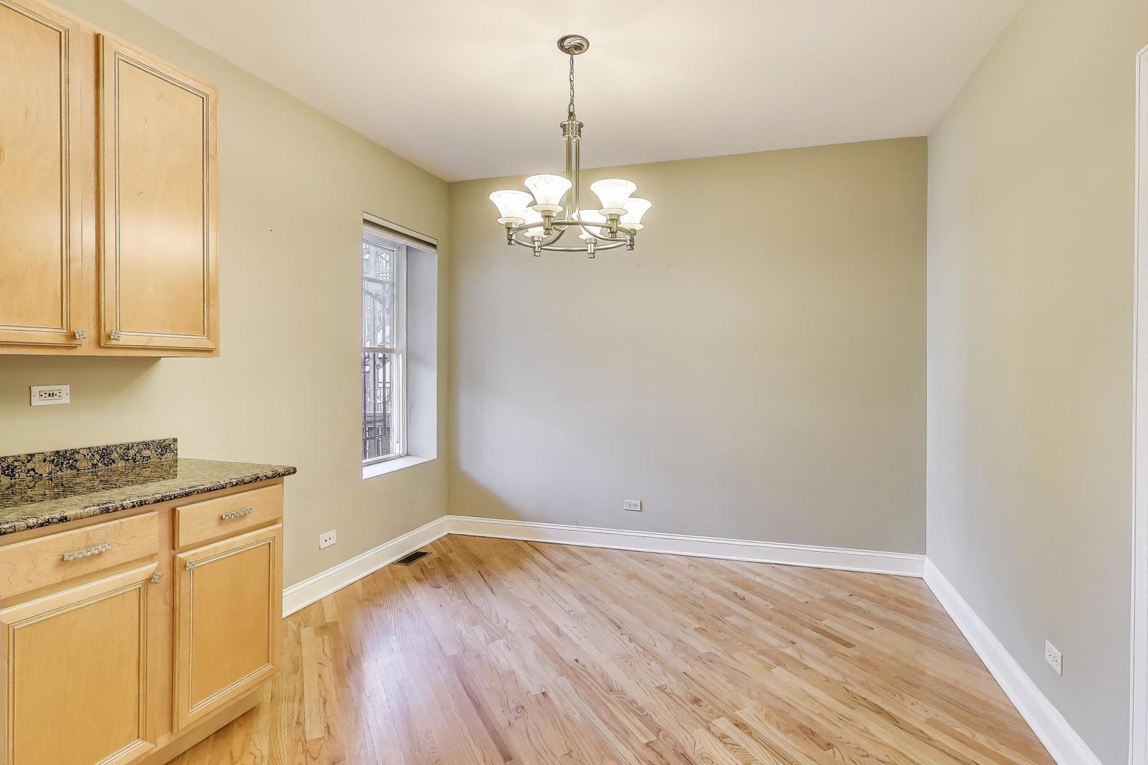 7730 North Paulina Street, Unit 1 Chicago, IL 60626 - Photo 9 of 59 a view of a kitchen with wooden floor and a window